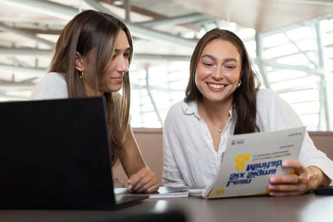 Olivia Pess with a peer at a desk.